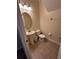 Cozy powder room with a pedestal sink and toilet, perfect for guests at 1452 Moon Valley Dr, Davenport, FL 33896