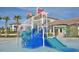 Community splash pad with two slides, water features, and palm trees at 1452 Moon Valley Dr, Davenport, FL 33896