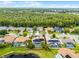 Beautiful aerial view of a home with a screened-in pool and solar panels, bordered by a lake and lush greenery at 14634 Astina Way, Orlando, FL 32837