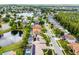 This aerial view highlights the home's pond-side location and proximity to community, nearby shopping, and local roadways at 14634 Astina Way, Orlando, FL 32837