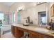 Bathroom with dual sinks, granite countertops, a large mirror, and a shower and bath tub at 14634 Astina Way, Orlando, FL 32837