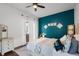 Bright bedroom featuring a ceiling fan, window with curtains, and a blue accent wall at 14634 Astina Way, Orlando, FL 32837