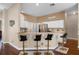 Kitchen with bar seating, white cabinets, stainless steel appliances, and tiled backsplash at 14634 Astina Way, Orlando, FL 32837