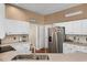 Bright kitchen with white cabinets, quartz countertops, and stainless steel appliances at 14634 Astina Way, Orlando, FL 32837