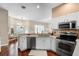 Modern kitchen with stainless steel appliances and bar overlooking dining area at 14634 Astina Way, Orlando, FL 32837