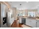 Bright kitchen with white cabinets, stainless steel refrigerator, and hardwood floors at 14634 Astina Way, Orlando, FL 32837