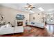 Bright living room features a fireplace, hardwood floors, skylights, and comfortable seating at 14634 Astina Way, Orlando, FL 32837