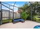 Comfortable patio seating with outdoor lounge chair under screened enclosure at 14634 Astina Way, Orlando, FL 32837
