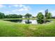Scenic pond in the community surrounded by lush green landscape at 14634 Astina Way, Orlando, FL 32837