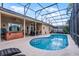 Inviting screened-in pool with hot tub and patio seating area at 14634 Astina Way, Orlando, FL 32837