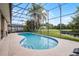 Beautiful screened pool and patio overlooking lush landscaping and pond at 14634 Astina Way, Orlando, FL 32837