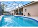 Sparkling blue pool with hot tub, outdoor kitchen, and screened enclosure at 14634 Astina Way, Orlando, FL 32837
