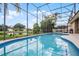 Refreshing screened-in pool boasts serene water views at 14634 Astina Way, Orlando, FL 32837