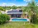 An aerial view of solar panels and a screened-in pool and patio at 14634 Astina Way, Orlando, FL 32837