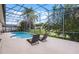 Screened pool deck with chaise lounges overlooking a pond and backyard at 14634 Astina Way, Orlando, FL 32837