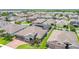 Aerial shot of a home with a brick driveway, three-car garage, and screened-in porch at 1556 Alligator St, St Cloud, FL 34771