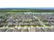 Aerial view of neighborhood featuring tidy streets, green lawns, and a picturesque lake at 1556 Alligator St, St Cloud, FL 34771