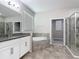 Large bathroom features granite counters, shower and separate soaking tub at 1556 Alligator St, St Cloud, FL 34771