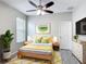 Bright bedroom is nicely decorated with modern furniture and a decorative ceiling fan at 1556 Alligator St, St Cloud, FL 34771