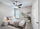 Cozy bedroom with wood-look floors, soft natural light, and modern decor at 1556 Alligator St, St Cloud, FL 34771