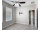 Bedroom featuring wood-look tile floors, ceiling fan, and natural light from a window at 1556 Alligator St, St Cloud, FL 34771