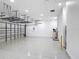 Large garage with bright lighting, painted floor, and wall-mounted storage racks for organized storage at 1556 Alligator St, St Cloud, FL 34771
