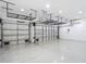 Spacious garage with overhead racks and insulated doors, providing ample storage and functionality at 1556 Alligator St, St Cloud, FL 34771