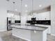 Modern kitchen features white cabinetry, granite countertops, and stainless steel appliances at 1556 Alligator St, St Cloud, FL 34771