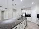 Bright kitchen boasts granite countertops, stainless steel appliances, and pendant lighting at 1556 Alligator St, St Cloud, FL 34771