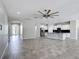 Open-concept living area featuring tile floors, white walls, and view to kitchen at 1556 Alligator St, St Cloud, FL 34771
