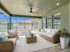 Relaxing screened patio featuring cozy wicker furniture, perfect for outdoor gatherings and relaxation at 1556 Alligator St, St Cloud, FL 34771