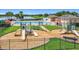 Community playground by the pool featuring slides, green space, and lake views at 1556 Alligator St, St Cloud, FL 34771