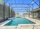 Screened-in pool area with water features, providing a luxurious outdoor experience at 1556 Alligator St, St Cloud, FL 34771