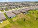 Aerial view of the backyard featuring a black metal fence and green grass at 1797 Sundance Chase Rd, Minneola, FL 34715