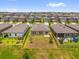 Aerial view of the backyard featuring a black metal fence and green grass at 1797 Sundance Chase Rd, Minneola, FL 34715