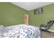 Green bedroom featuring wood floors, a tv, and a massage chair at 1797 Sundance Chase Rd, Minneola, FL 34715