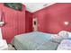 Red bedroom featuring a closet and adjacent room entrance at 1797 Sundance Chase Rd, Minneola, FL 34715