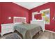Red bedroom featuring wood floors, two windows, and a teddy bear at 1797 Sundance Chase Rd, Minneola, FL 34715