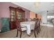 Formal dining room featuring wood floors, ornate china cabinet, and elegant chandelier at 1797 Sundance Chase Rd, Minneola, FL 34715