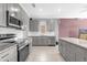 A modern kitchen with stainless steel appliances, granite countertops and island at 1797 Sundance Chase Rd, Minneola, FL 34715