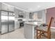 A well-equipped kitchen featuring stainless appliances, a granite island, and ample storage at 1797 Sundance Chase Rd, Minneola, FL 34715