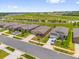 Street view of the neighborhood featuring modern homes with well-maintained lawns and landscaping at 1797 Sundance Chase Rd, Minneola, FL 34715