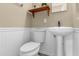 Charming half bathroom featuring a pedestal sink and a stylish wood shelf perfect for guests at 1945 Bering Ave, Winter Park, FL 32789