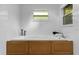 Bright bathroom featuring a white tiled tub with wood paneling and natural light from the windows at 1945 Bering Ave, Winter Park, FL 32789