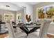 Inviting dining area featuring a glass table set for four, modern decor, and abundant natural light at 1945 Bering Ave, Winter Park, FL 32789