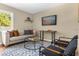 Cozy living room featuring a comfortable sofa, stylish rug, and mounted TV for relaxation and entertainment at 1945 Bering Ave, Winter Park, FL 32789