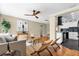 Bright living room with hardwood floors, stylish furniture, modern fan, and an open view of the kitchen at 1945 Bering Ave, Winter Park, FL 32789