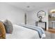 Calm main bedroom featuring a round mirror, accent table, and neutral decor for a serene and relaxing space at 1945 Bering Ave, Winter Park, FL 32789