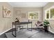 Bright home office with modern desk, leather chair, and ample natural light, ideal for focused work at 1945 Bering Ave, Winter Park, FL 32789