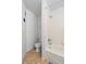 Small bathroom with a toilet and a shower tub with white tiles and tan tile flooring at 1950 Summer Club Dr # 200, Oviedo, FL 32765